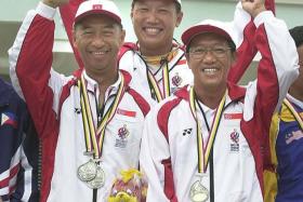 A WINNER IN EVERY SENSE: Chng Seng Mok (far right), with shooting teammates Kwa Eng Cheong (far left) and Lee Wung Yew (centre) after winning the men&#039;s trap team gold at the 2001 SEA Games.