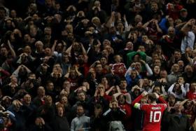 GOOD AND BAD: The Old Trafford fans showing their frustration at another poor Wayne Rooney (above) display but the form of Juan Mata is one of the reasons they are top of the English Premiership.