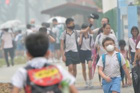 Students of Mayflower Primary School taking precautionary measures by wearing masks as hazy skies returned as schools across Singapore reopened on Sept 28.