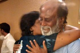 ELATED: Madam Sandanam gives Rajinikanth a hug and a kiss.