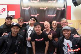 WINNER: Steven Chew (centre, in black T-shirt) won a contest to meet his idols Joe Elliot (fourth from left), Phil Collen (sixth from left), and Vivian Campbell (seventh from left) of Def Leppard when they were at the ONE FM 91.3 studio for an interview with the #1 Breakfast Show team.