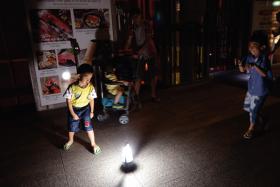 Children playing around a light on the seventh floor of Orchard Central