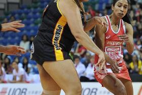 CLOSE CONTEST: Singapore&#039;s Premila Hirubalan (in red) fighting for the ball with Tiata Baldwin.