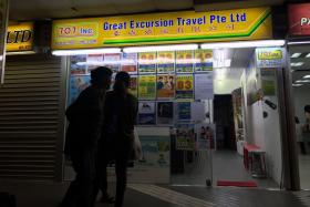 The exterior of 707-Inc Great Eastern Travels at Golden Mile Complex.
They have resorted to printing posters telling people that they have not closed down