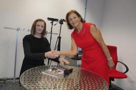 HUMANOID: Professor Nadia Thalmann (in red) shaking hands with the robot she created, Nadine.