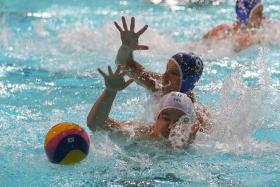 GULF IN STANDARDS: A water polo player from Slovakia&#039;s KVP U-18 team (in blue cap) helping his team to  a 12-4 win over Singapore Under-23 at the Toa Payoh Swimming Complex yesterday.