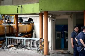 TOPPLED: The mobile construction crane crashed through the wall of a POSB branch at Block 2A, Woodlands Centre
Road. 