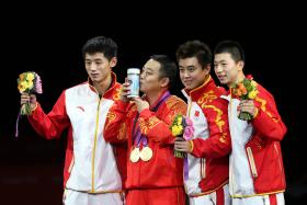 LEAGUE OF THEIR OWN: Liu Guoliang (second from left) celebrating the men's team gold medal with his players at the 2012 London Olympics. 