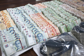 Police recovered $433,000 cash and a range of luxury goods such as wallets, belts and shoes.