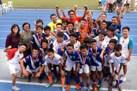 CELEBRATION TIME:   (Above) Tanjong Katong C Boys celebrating with their coaches and teachers after receiving  their medals..

