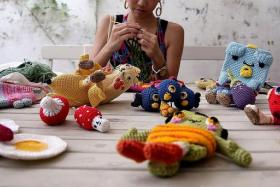 CURRENT PROJECT: Ms Lim with some of the items she has crocheted. Most of them have what she calls her signature ‘monster eyeballs’.