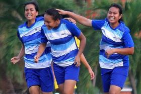 JOYFUL: Natasha Azhar (right) and Riddle Renelynn Sison (left) celebrating with Ong Yan Ting after she scored the opening goal.