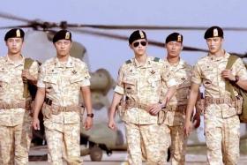 ARMY DAYS: Captain Yoo Si Jin (Song Joong Ki, with sunglasses) and Sergeant Major Seo Dae Young (Jin Goo, second from left) in a scene from Descendants Of The Sun.