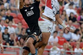 TIGHT TUSSLE: All Blacks&#039; Regan Ware (left) and USA&#039;s Maka Unufe vying for the ball. New Zealand won 19-12.