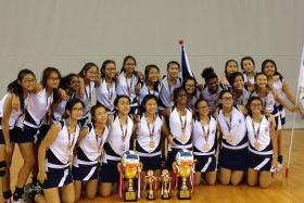DOMINANT FORCE: The B and C Division Girls from CHIJ (Toa Payoh) posing with their medals and trophies after winning their respective finals yesterday.