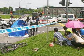TRAGIC: Madam Lin&#039;s grief-stricken family members being restrained at the scene of the accident in Yishun.