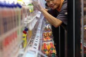 SERVICE: Mr Louis Chua works as a store assistant at FairPrice Finest’s Changi Airport Terminal 3 branch.