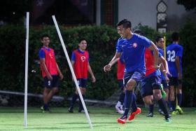 OLD HEAD: Garena Young Lions striker Khairul Amri (above, in the foreground) is one of three senior players in the developmental team and uses his vast experience to guide his teammates.