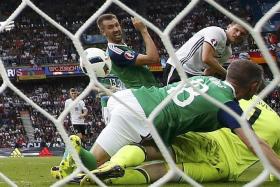 ONE UP: Mario Gomez (top right) putting the ball past Northern Ireland goalkeeper Michael McGovern for Germany&#039;s only goal.  