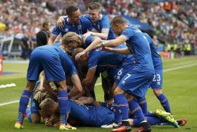 THAT&#039;S NICE: Iceland&#039;s players celebrating Jon Dadi Bodvarsson&#039;s goal.