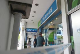 CLOSED: Police cordoned off the area in front of Standard Chartered bank at Holland Avenue after a rare robbery. 