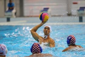 MAIDEN SUCCESS: NUS&#039; Ang An Jun helping Singapore narrowly beat Indonesia in the men&#039;s water polo final at the 18th Asean University Games yesterday. This is the first time the sport is featuring in the Games.