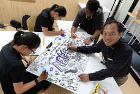 TALENTED: (Above) Mr Liew doodling with his art class students.
