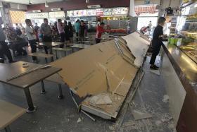 SCARE: The incident on Wednesday, in which a 10m-long signboard fell, seemed to have had little effect on business in the coffee shop, where queues (above) could still be seen.