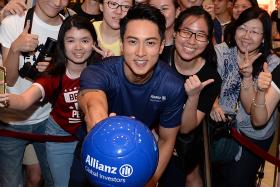 POPULAR: Wu Chun with fans at the launch of Art In Your Life Youth Design Campaign (Asia Pacific) at Suntec City West Atrium. 