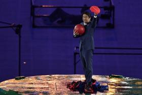 Shinzo Abe, dressed as Mario, appeared on stage from a green pipe, Super Mario style.