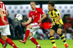 IN THE HUNT: Dortmund&#039;s  Shinji Kagawa (right) closes down Bayern&#039;s Franck Ribery during the German Supercup, which Bayern won 2-0.