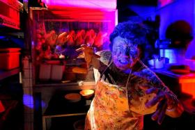 YOU&#039;RE DEAD MEAT: A zombie in front of her chicken rice stall from the Hawker Centre Massacre.