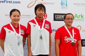 GOLDEN GIRL: Minami Takahashi (centre) wins the 12-year-old girls&#039; 50m backstroke, ahead of Honoka Ishige (left)  and Singapore&#039;s Elena Lee Lee Na Pedersen (right).