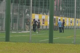 Police officers at Geylang Methodist Secondary School where a boy died after a goalpost fell on him.