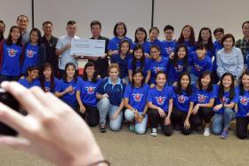 Mr Henry Tan, Managing Director of Nexis TS presenting a cheque to Mr Kenneth Ho, President of Singapore Floorball Association.