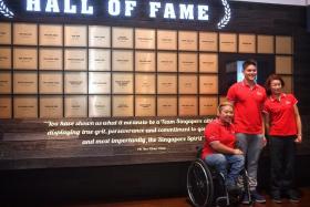 From left: Theresa Goh, Joseph Schooling and Laurentia Tan, in front of the Sport Hall of Fame at the Singapore Sports Hub on Tuesday. The trio are the latest inductees in the Hall of Fame.