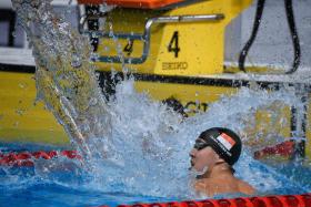 Zheng Wen in rare show of emotion after 100m back win