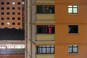 The flat (centre, with dim red light) in Jurong West Street 61 where a brothel operates. Residents said that for the last one year, the rented unit has housed a number of foreign women.