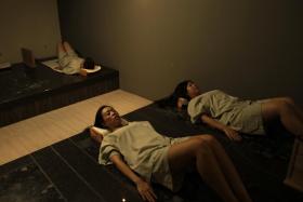 Customers lie on heated volcanic rock beds for an hour and the treatment is said to help the body release toxins through perspiration.
