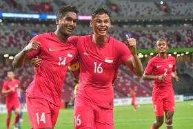 Singapore captain Hariss Harun (No. 14) celebrating with Irfan Fandi after scoring the first goal.