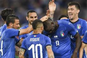 Mario Balotelli (No. 9) gets feted by his teammates after scoring for Italy.