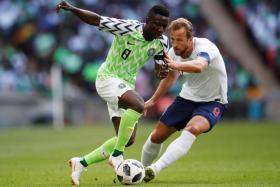 Nigeria's Oghenekaro Peter Etebo (left) in action with Harry Kane during an international friendly on June 12.