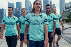 (From left) Arsenal&#039;s players Henrikh Mkhitaryan, Mesut Oezil, Hector Bellerin, Pierre-Emerick Aubameyang and Petr Cech unveiling the club&#039;s third kit at the Esplanade in Singapore on Friday (July 27).