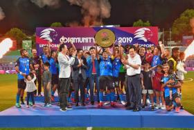 Home United skipper Izzdin Shafiq lifting the AIA Community Shield after a penalty shoot-out win over Albirex Niigata.