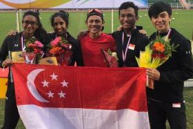 Singapore&#039;s mixed relay quartet of (in black, from left) Kugapriya Chandran, Shanti Pereira,  Khairyll Amri and Tan Zong Yang, with their coach Hamkah Afik (centre, in red).