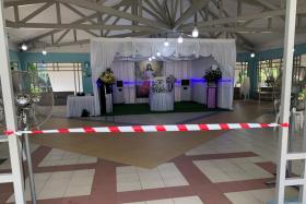 The wake of the writer’s father with tape cordoning off entrances and few tables and chairs provided to discourage mourners from gathering.