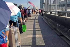 Pictures widely shared on social media sites yesterday showed people queueing to cross the Causeway to Malaysia. 