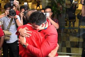 Joseph Schooling hugs his father Colin after returning to Singapore from Rio de Janeiro in 2016, following his Olympic victory in the 100m butterfly. 