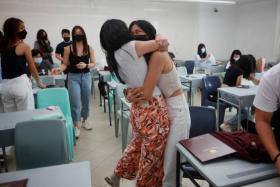 Students from ACS (Independent)'s class of 2021 embrace after receiving their IB results on Jan 4, 2021. 