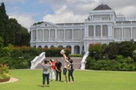 A family taking a photo on the Istana premises at last year&#039;s Open House on Aug 28, 2021.